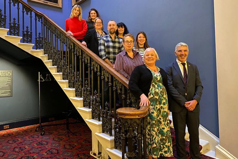 Nine people on a set of stairs 
